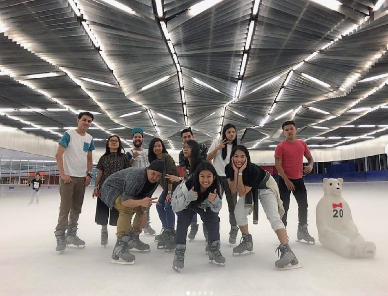 The design team posing together at an ice skating rink